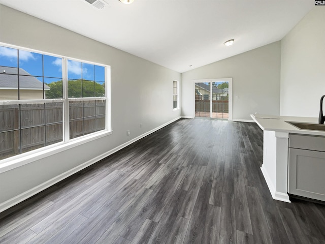 8 Brushwood Ct, Columbia, SC 29229 - unfurnished living room with a sink, vaulted ceiling, dark wood-style floors, and baseboards