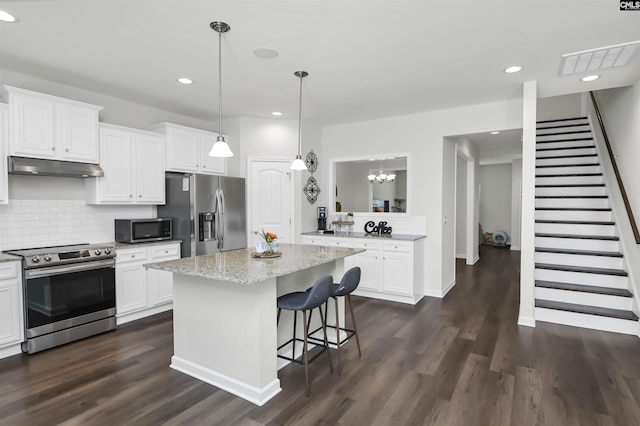 436 N Cobia Ct, Irmo, SC 29063 - kitchen featuring stainless steel appliances, under cabinet range hood, dark wood-style flooring, white cabinetry, and a center island