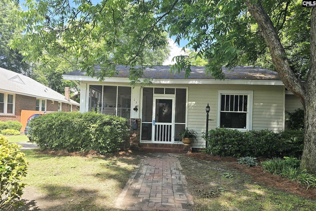 view of front of house featuring a sunroom