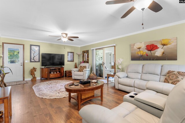 living area with ceiling fan, wood finished floors, ornamental molding, and baseboards