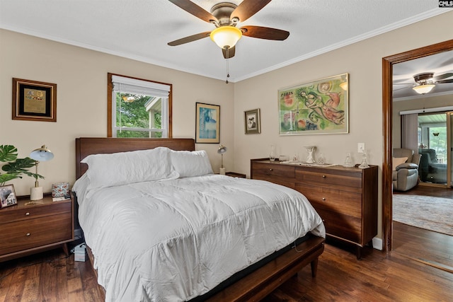 bedroom with dark wood-type flooring, ornamental molding, and ceiling fan