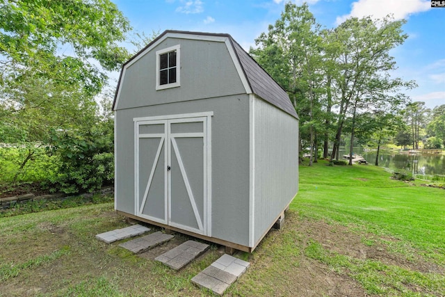 view of shed with a water view