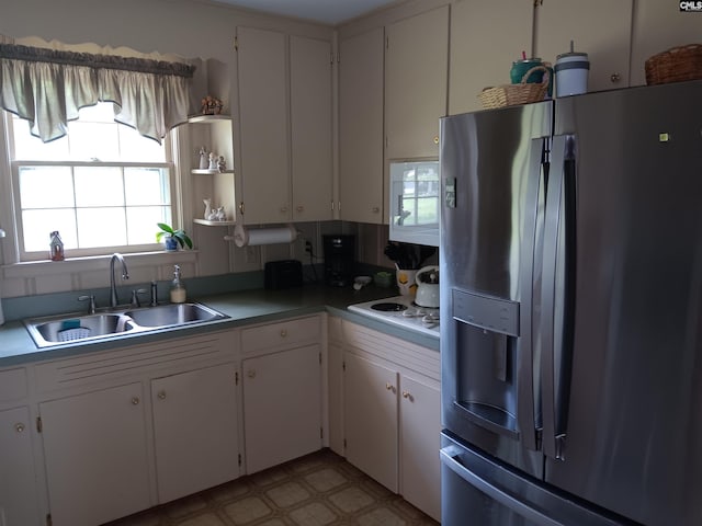 6603 Christie Rd, Columbia, SC 29209 - kitchen featuring white appliances, a sink, plenty of natural light, and white cabinets