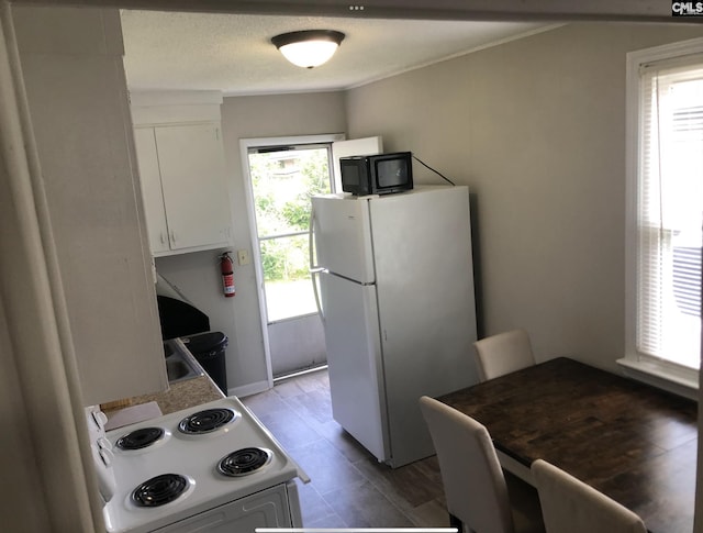 59 Dumont St, Columbia, SC 29201 - kitchen with white appliances and white cabinets