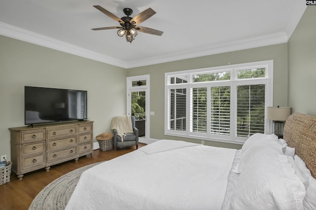 bedroom featuring wood finished floors, ornamental molding, and ceiling fan