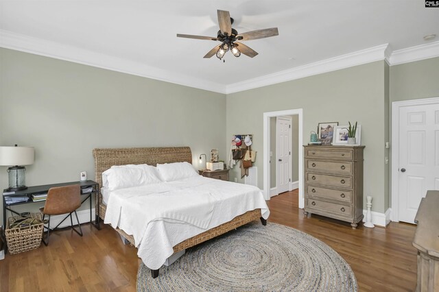 bedroom with ornamental molding, wood finished floors, baseboards, and ceiling fan