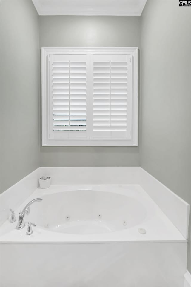 full bathroom featuring a tub with jets and crown molding