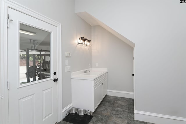 bathroom featuring baseboards and vanity