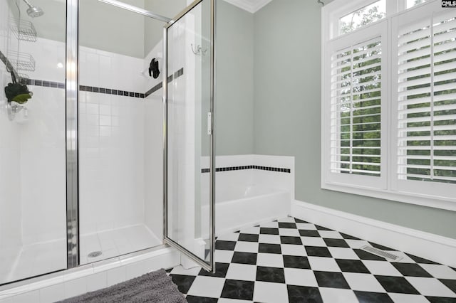 bathroom featuring a stall shower, a bath, and tile patterned floors