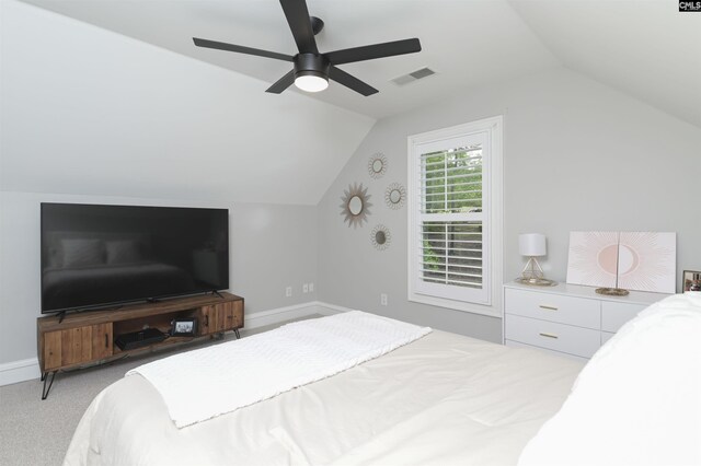 carpeted bedroom with lofted ceiling, a ceiling fan, and baseboards
