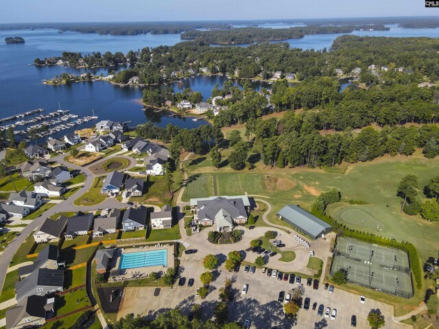 aerial view of property and surrounding area with a large body of water and a golf course