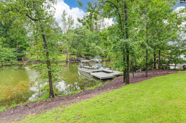 dock featuring a water view and a yard