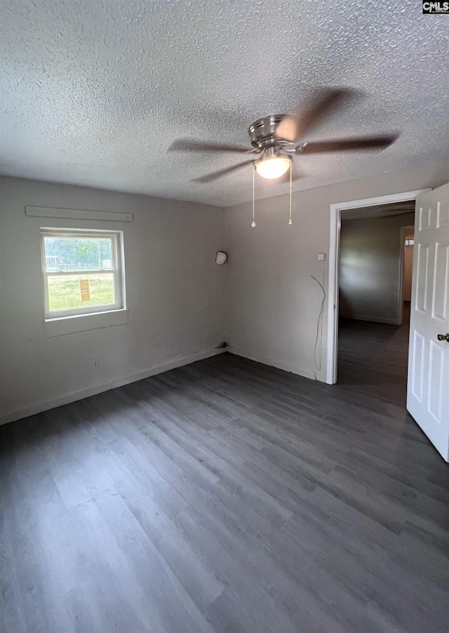 914 Prescott Rd, Columbia, SC 29203 - spare room featuring dark wood-style flooring, a textured ceiling, ceiling fan, and baseboards