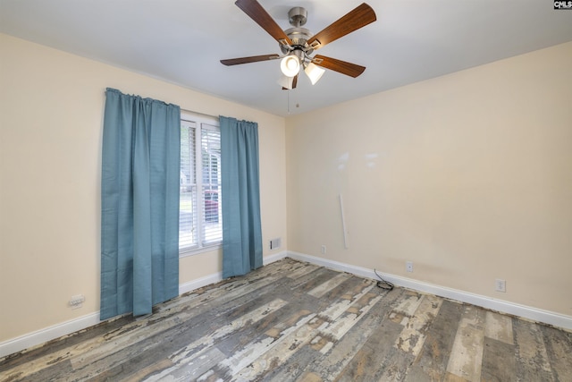 empty room featuring baseboards, wood finished floors, and ceiling fan