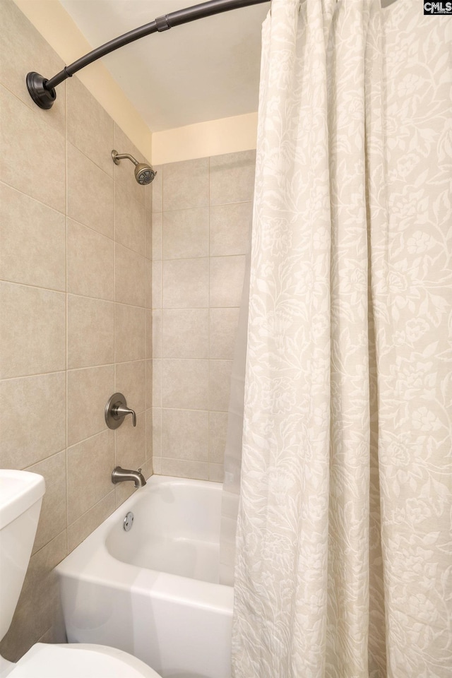 bathroom with shower / tub combo and toilet