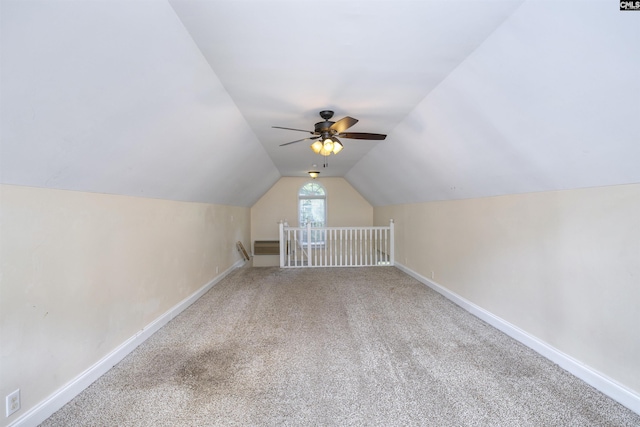 bonus room featuring vaulted ceiling, carpet floors, baseboards, and ceiling fan