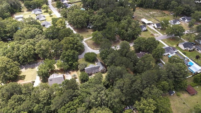 aerial view of property and surrounding area featuring nearby suburban area