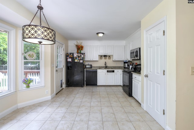 kitchen featuring black appliances, white cabinetry, a sink, hanging light fixtures, and light tile patterned floors