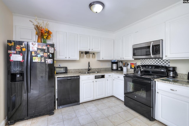 kitchen with black appliances, a sink, white cabinets, light tile patterned floors, and ornamental molding