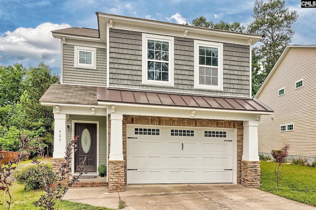409 Denman Loop, Columbia, SC 29229 - view of front of property with a standing seam roof, an attached garage, driveway, and metal roof
