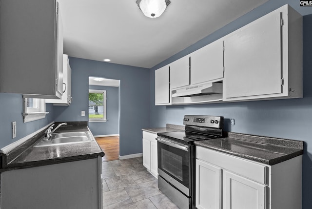 7608 Stone St, Columbia, SC 29209 - kitchen featuring stainless steel range with electric stovetop, under cabinet range hood, a sink, and dark countertops