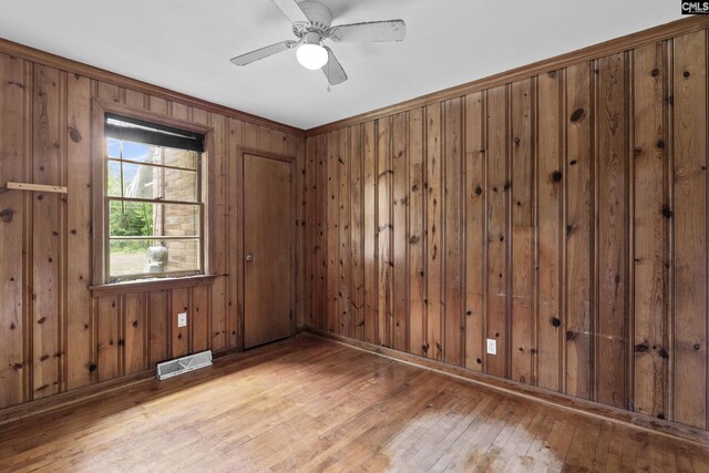 7608 Stone St, Columbia, SC 29209 - unfurnished room with hardwood / wood-style flooring, wood walls, ceiling fan, and baseboards