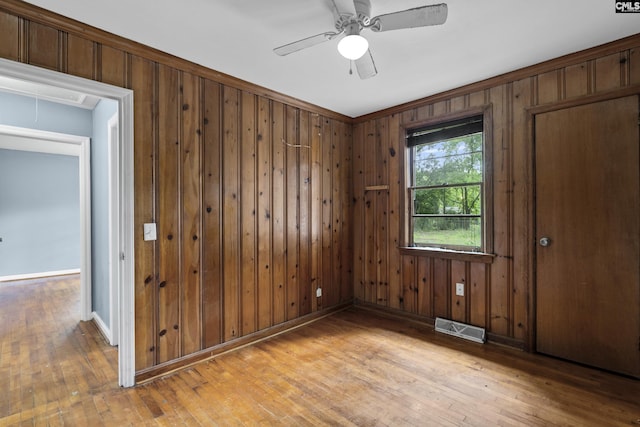 7608 Stone St, Columbia, SC 29209 - spare room featuring light wood-type flooring, ceiling fan, attic access, wooden walls, and baseboards