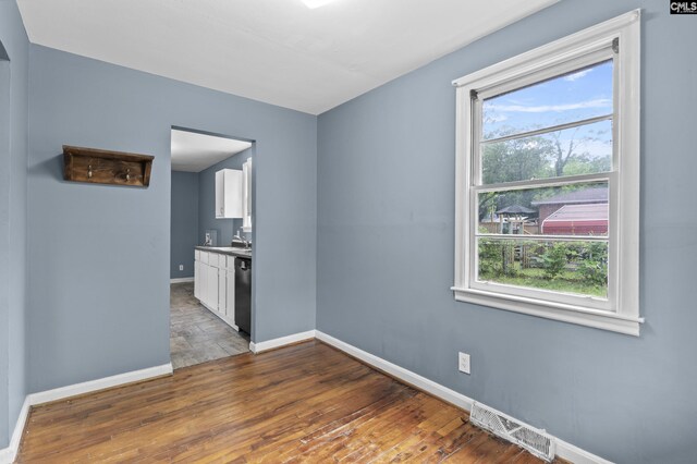 7608 Stone St, Columbia, SC 29209 - unfurnished room with baseboards, dark wood-type flooring, and plenty of natural light