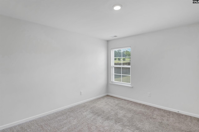 unfurnished room featuring baseboards and carpet