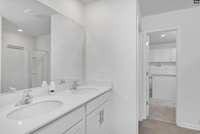 bathroom with a stall shower, double vanity, recessed lighting, and tile patterned flooring