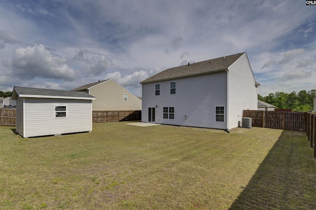 rear view of property featuring an outbuilding, cooling unit, and a storage unit
