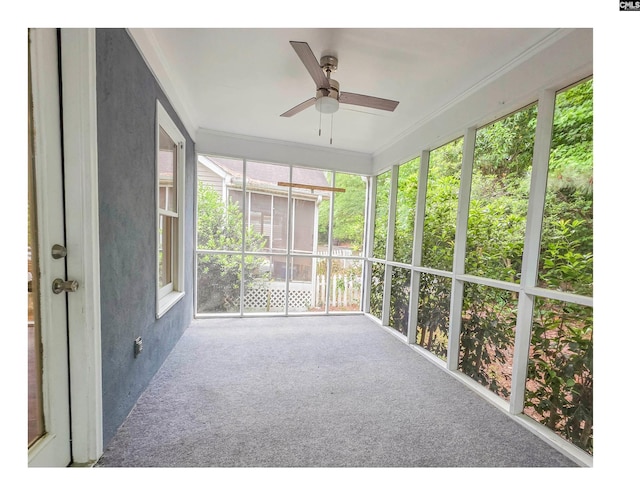 unfurnished sunroom with a ceiling fan