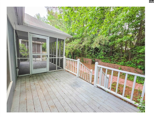 wooden deck with a sunroom