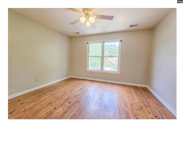 unfurnished room featuring wood finished floors, baseboards, and ceiling fan