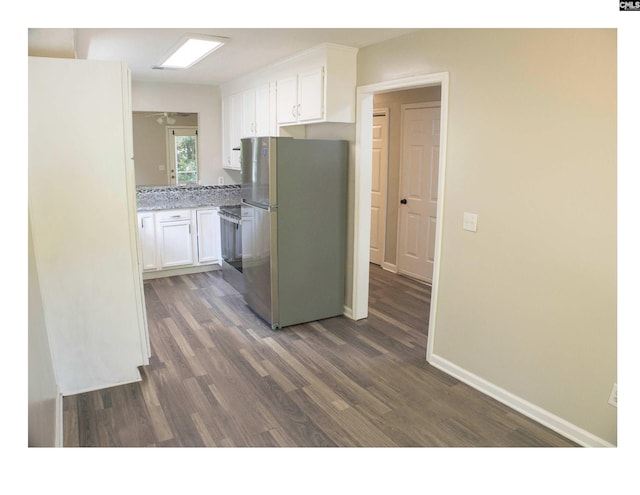 kitchen with stainless steel appliances, dark wood-style floors, white cabinetry, and baseboards