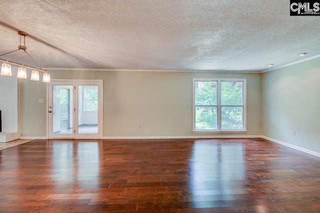 7905 Castleton Ln, Columbia, SC 29223 - unfurnished living room featuring plenty of natural light, wood finished floors, a textured ceiling, a brick fireplace, and ornamental molding