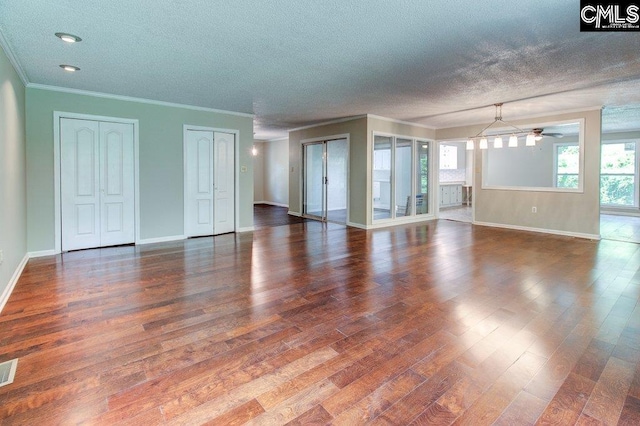 7905 Castleton Ln, Columbia, SC 29223 - unfurnished living room featuring baseboards, dark wood-type flooring, crown molding, a textured ceiling, and ceiling fan