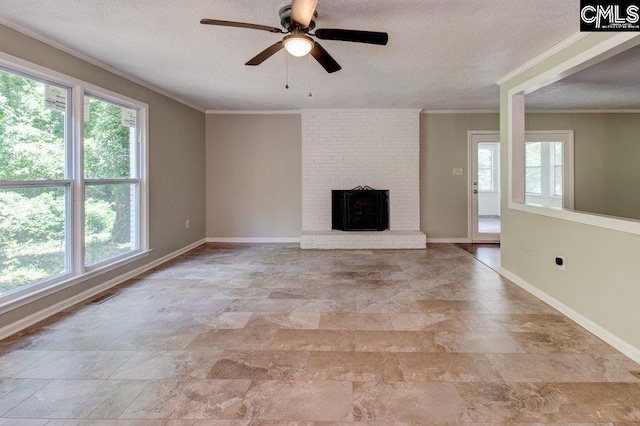 7905 Castleton Ln, Columbia, SC 29223 - unfurnished living room with stone finish floors, healthy amount of natural light, ornamental molding, a textured ceiling, and baseboards