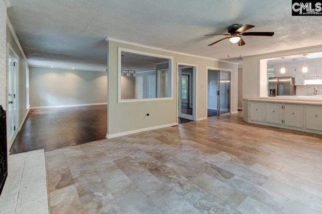 7905 Castleton Ln, Columbia, SC 29223 - unfurnished living room with a textured ceiling, ceiling fan, baseboards, and ornamental molding