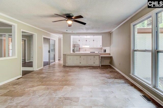 7905 Castleton Ln, Columbia, SC 29223 - unfurnished living room with a ceiling fan, crown molding, a textured ceiling, baseboards, and stone finish floors