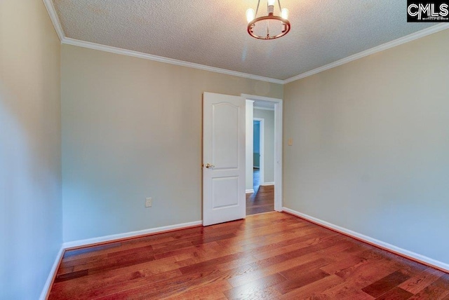 7905 Castleton Ln, Columbia, SC 29223 - empty room with a textured ceiling, wood finished floors, a chandelier, baseboards, and ornamental molding