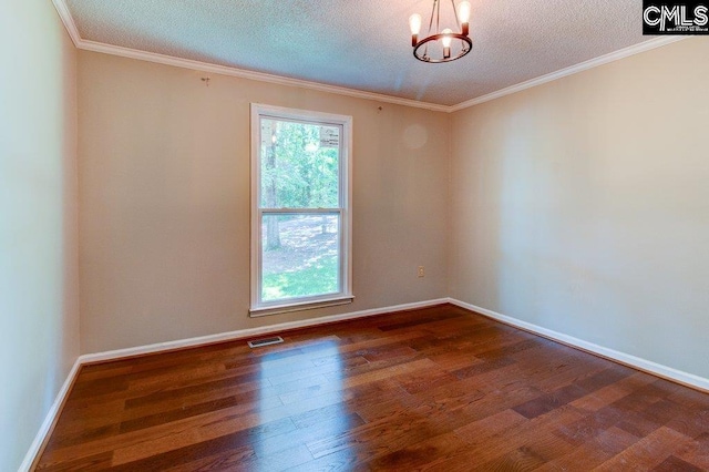 7905 Castleton Ln, Columbia, SC 29223 - spare room featuring a chandelier, a textured ceiling, wood finished floors, crown molding, and baseboards