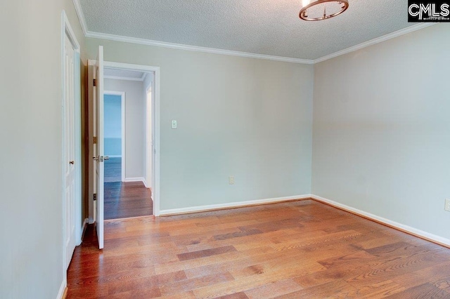 7905 Castleton Ln, Columbia, SC 29223 - spare room with wood finished floors, a textured ceiling, ornamental molding, and baseboards