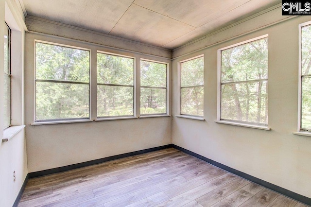 7905 Castleton Ln, Columbia, SC 29223 - unfurnished sunroom with baseboards, wood finished floors, and a wooden deck