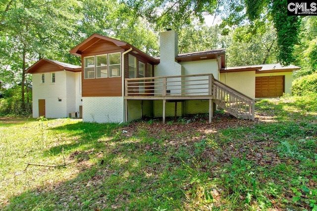 7905 Castleton Ln, Columbia, SC 29223 - rear view of property featuring a chimney, brick siding, a wooden deck, a sunroom, and a garage
