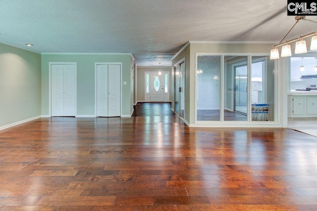 7905 Castleton Ln, Columbia, SC 29223 - unfurnished living room featuring ornamental molding, wood finished floors, a textured ceiling, and baseboards