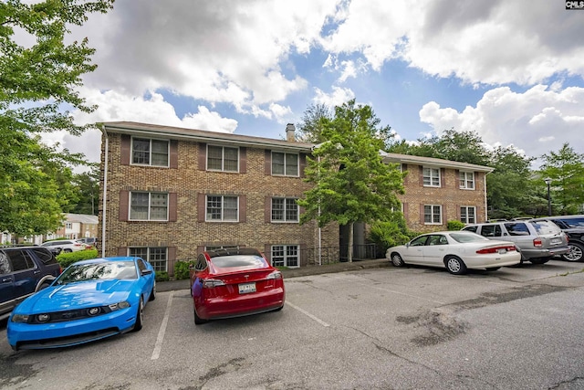 view of building exterior with uncovered parking