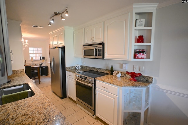 2 Indian Creek Trl, Lexington, SC 29072 - kitchen with stainless steel appliances, white cabinets, a chandelier, and light stone counters