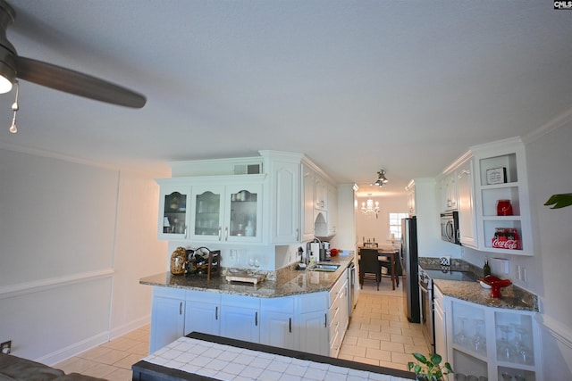 2 Indian Creek Trl, Lexington, SC 29072 - kitchen with stainless steel appliances, a sink, light tile patterned floors, a chandelier, and white cabinetry