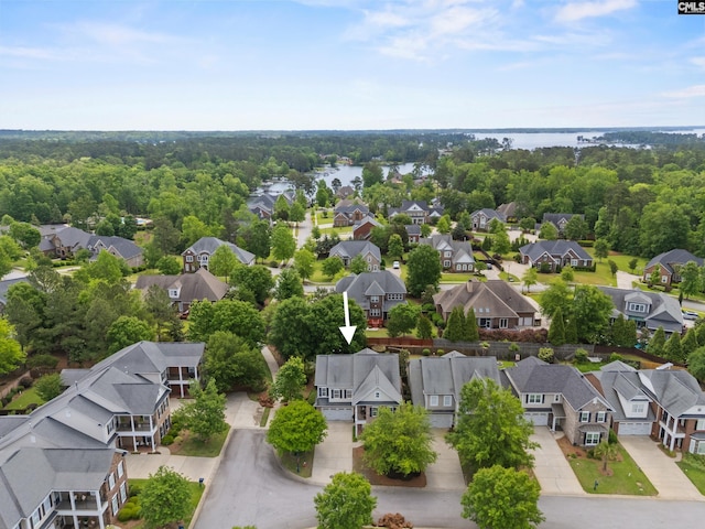 aerial view of residential area featuring a large body of water